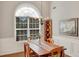 Inviting dining room featuring a large window, chandelier, and beautiful wood table at 2450 Cordillo Ne Dr, Dacula, GA 30019