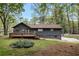 Exterior view of home, highlighting a large deck and tree-lined backyard at 2512 Hidden Hills Dr, Marietta, GA 30066