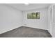 Bright bedroom featuring a large window with wooded view and closet with louvered doors at 2512 Hidden Hills Dr, Marietta, GA 30066