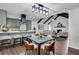 Open dining area with stylish light fixture, chairs, and views of kitchen and living area at 2512 Hidden Hills Dr, Marietta, GA 30066
