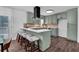 Modern kitchen with stainless appliances, white quartz counters, and light green cabinets at 2512 Hidden Hills Dr, Marietta, GA 30066