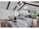 Bright open-concept living room features vaulted ceilings with beams, modern furniture and hardwood floors at 2512 Hidden Hills Dr, Marietta, GA 30066