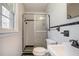 Bathroom with a glass shower, toilet, sink with a window allowing lots of natural light at 803 Denise Sw Ct, Stone Mountain, GA 30087