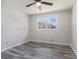 Bedroom featuring a ceiling fan, double windows for natural light, and luxury vinyl flooring at 803 Denise Sw Ct, Stone Mountain, GA 30087