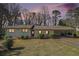 Charming single-story home with stone accents and a covered carport at dusk at 803 Denise Sw Ct, Stone Mountain, GA 30087
