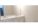 Bathroom featuring double sinks with a large mirror and white cabinetry at 1062 Crest Mill Dr, Marietta, GA 30008