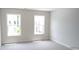 Empty bedroom with light gray carpet and two windows at 1062 Crest Mill Dr, Marietta, GA 30008