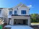 New two-story home with a brick-lined garage and light gray siding under a sunny sky at 1075 Crest Mill Dr, Marietta, GA 30008