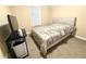 Neutral bedroom features a bed with carpet and a small TV setup for relaxing at 3179 Dunlin Lake Rd, Lawrenceville, GA 30044