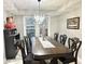 Elegant dining room with a large table, decorative chandelier, and sleek marble-look floors at 3179 Dunlin Lake Rd, Lawrenceville, GA 30044