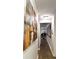 Hallway with wood floors featuring colorful paintings hanging on the walls at 3179 Dunlin Lake Rd, Lawrenceville, GA 30044