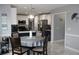 Modern kitchen featuring stainless steel appliances, pendant lighting, and a dining table at 3179 Dunlin Lake Rd, Lawrenceville, GA 30044