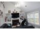 Cozy living room features a fireplace, built-in shelving, and multiple windows for natural light at 3179 Dunlin Lake Rd, Lawrenceville, GA 30044