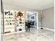 Bright, open living area featuring decorative shelving and marble-look tile flooring at 3179 Dunlin Lake Rd, Lawrenceville, GA 30044