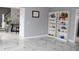 Bright living room with white marble floors and contemporary decorative shelving at 3179 Dunlin Lake Rd, Lawrenceville, GA 30044