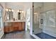 Bathroom showcasing wood vanity with double sinks, a marble shower, and black floor at 2159 James Aly, Atlanta, GA 30345