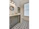 Bathroom showcasing decorative tile floor, a round mirror, and a gray vanity with modern fixtures at 2159 James Aly, Atlanta, GA 30345