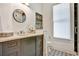 Bathroom with decorative tile floor, a round mirror, gray vanity, and modern fixtures at 2159 James Aly, Atlanta, GA 30345