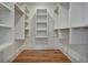 Walk-in closet featuring wood floor and shelving in a spacious, well-organized design at 2159 James Aly, Atlanta, GA 30345