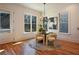 Elegant dining room features a modern chandelier, large windows, and hardwood floors, great for gatherings at 2159 James Aly, Atlanta, GA 30345