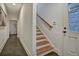 Hallway with tile floors leading to stairs and entry door at 2159 James Aly, Atlanta, GA 30345