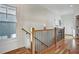 Hallway featuring hardwood floors, railing with black iron balusters, and natural light from a window at 2159 James Aly, Atlanta, GA 30345