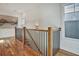 Hallway featuring hardwood floors, railing with black iron balusters, and natural light from a window at 2159 James Aly, Atlanta, GA 30345