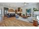 Open-concept living room featuring hardwood floors, modern lighting, kitchen island and stylish contemporary furniture at 2159 James Aly, Atlanta, GA 30345
