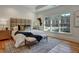 Main bedroom with tray ceiling, a king bed with upholstered headboard, and natural light at 2159 James Aly, Atlanta, GA 30345
