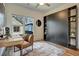 Bright and airy office space featuring a murphy bed, desk, chair, and stylish built-in shelving at 2159 James Aly, Atlanta, GA 30345