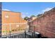 Cozy balcony featuring a chair, small table, and views of neighboring brick buildings against a blue sky at 385 Ralph Mcgill Ne Blvd # D, Atlanta, GA 30312