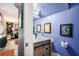 Small half bathroom with artwork, toilet paper holder and wood vanity cabinet at 385 Ralph Mcgill Ne Blvd # D, Atlanta, GA 30312