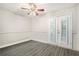 Bedroom features gray wood laminate flooring, french doors, neutral walls, and ceiling fan at 385 Ralph Mcgill Ne Blvd # D, Atlanta, GA 30312