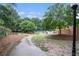 Scenic community path leading to a pool, lined with mature trees and lush greenery at 385 Ralph Mcgill Ne Blvd # D, Atlanta, GA 30312