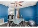Bright dining room featuring a glass-top table, ceiling fan, and blue painted walls at 385 Ralph Mcgill Ne Blvd # D, Atlanta, GA 30312