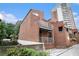 Brick townhouse showcasing side exterior with unique architectural design, balconies, and some green foliage at 385 Ralph Mcgill Ne Blvd # D, Atlanta, GA 30312