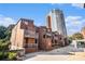 Brick townhouses nestled amongst lush trees and a modern high-rise building in a vibrant urban setting at 385 Ralph Mcgill Ne Blvd # D, Atlanta, GA 30312