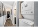 Hallway view featuring wood floors, art pieces, and an in-unit stacked washer/dryer at 385 Ralph Mcgill Ne Blvd # D, Atlanta, GA 30312
