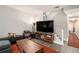 Modern living room features a TV, wood accent furniture, gray sofa, and gray wood laminate flooring at 385 Ralph Mcgill Ne Blvd # D, Atlanta, GA 30312