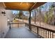 Covered back porch with wood ceiling, views of wooded backyard at 541 Glen Abbey Se Cir, Mableton, GA 30126