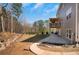 Wide shot of large backyard featuring a well-maintained lawn, landscaping and concrete walkway at 541 Glen Abbey Se Cir, Mableton, GA 30126