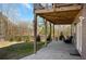 Landscaped backyard featuring a well-maintained lawn and a covered patio at 541 Glen Abbey Se Cir, Mableton, GA 30126