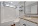 Clean bathroom featuring a shower-tub combo and granite countertop sink at 541 Glen Abbey Se Cir, Mableton, GA 30126