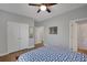 Bedroom with hardwood flooring, ceiling fan, and a double door closet at 541 Glen Abbey Se Cir, Mableton, GA 30126