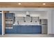 A contemporary kitchen design featuring blue cabinets, stainless appliances, and marble countertops at 541 Glen Abbey Se Cir, Mableton, GA 30126