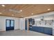 Modern kitchen boasts sleek blue cabinetry, stainless appliances, and stylish wood plank ceiling at 541 Glen Abbey Se Cir, Mableton, GA 30126