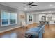 Open-concept living room that flows to a kitchen with hardwood flooring and lots of natural light at 541 Glen Abbey Se Cir, Mableton, GA 30126