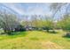 Spacious backyard featuring a well-maintained lawn and mature trees at 5415 Tracey Dr, Stone Mountain, GA 30088