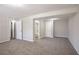 Spacious finished basement featuring neutral walls, carpet, two lights, and multiple doors leading to other rooms at 5415 Tracey Dr, Stone Mountain, GA 30088