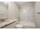 Bathroom featuring a granite countertop, white cabinets, and white tiled shower and tub combo at 5415 Tracey Dr, Stone Mountain, GA 30088